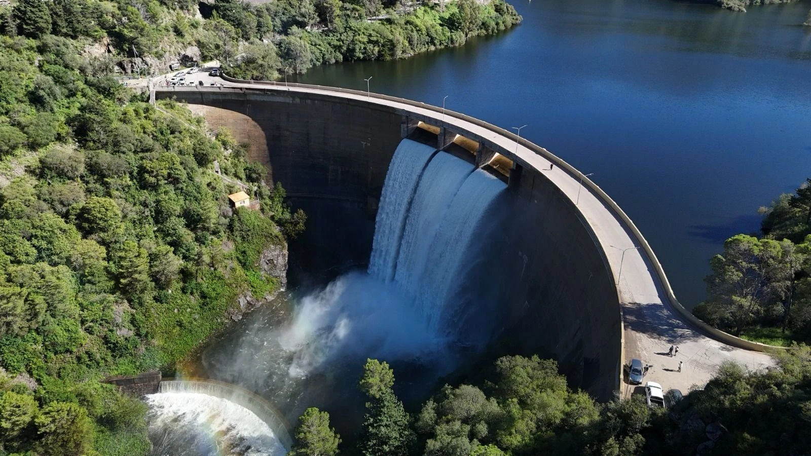 An arch dam spilling through three gates